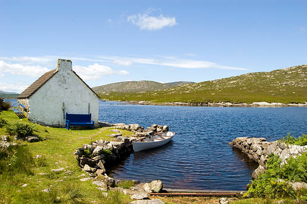 Lakeside cottage and small boat in Connemara, Ireland My Lightboxes: connemara stock pictures, royalty-free photos & images