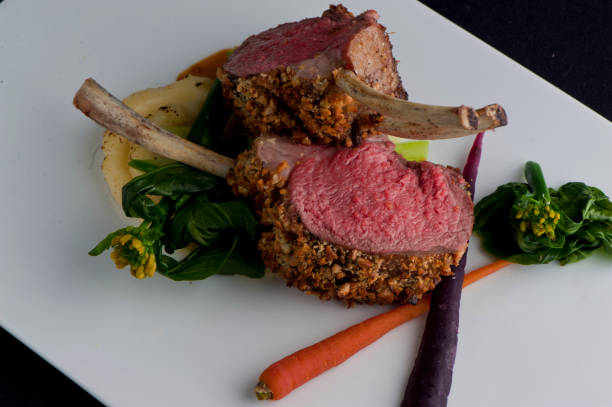 Lamb chops. Rack of lamb. Grade A grass fed angus beef steaks. Tenderloin, filet mignon, New York strip, bone in rib-eye grilled to perfect medium rare on outdoor wood-fired grill. Classic American steakhouse entree favorite. stock photo