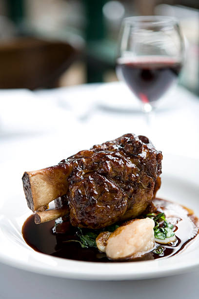 Lamb shanks with jus and red wine stock photo