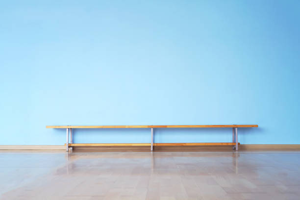 laminate floor and empty blue wall with wooden bench wide laminate floor and huge empty blue wall in empty room with wooden bench bench stock pictures, royalty-free photos & images