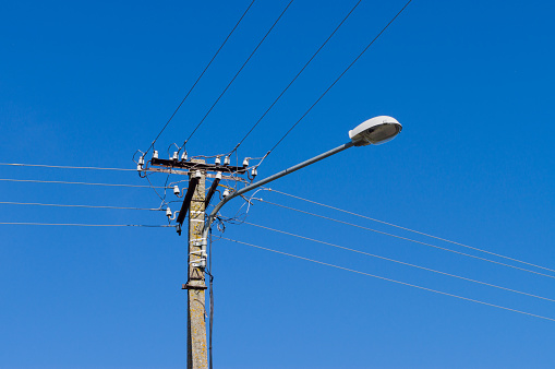 Lamppost with many electrical wires