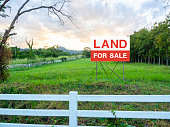 istock Land for sale sign on empty land. 1303409516