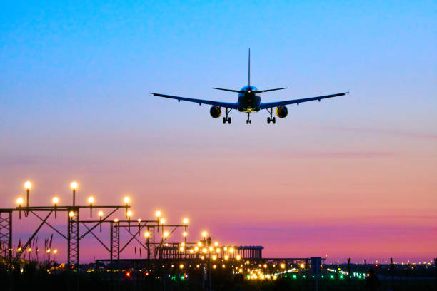 Landing airplane during sunset - Barcelona "El Prat Aeroport" stock photo