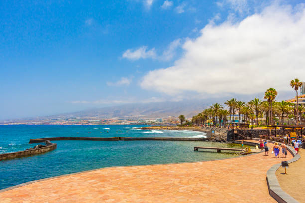 Landscape and beach promenade panorama of Playa de las Americas of Canary Spanish island Tenerife in Africa. stock photo