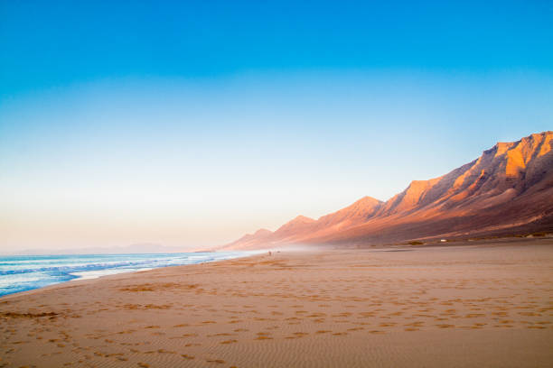 Landscape of Jandía beach, one of the main in Fuerteventura island, Canary Island, Lanzarote. The landscape of Jandía beach, one of the main in Fuerteventura Island, Canary Island, Lanzarote. is a summer day, there are mountains and a blue sky. canary islands stock pictures, royalty-free photos & images