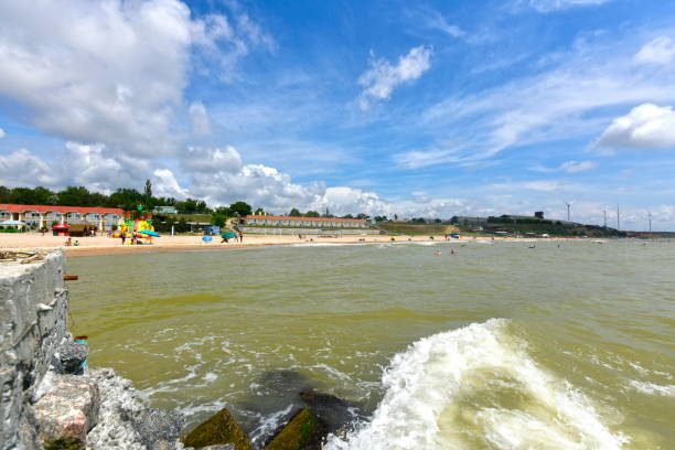Landscapes of the sea. Ukraine, Primorsk 06/22/2020. Azov sea beach in Dorozhnik resort. Bungalows, sun loungers, vacationers and swimmers. zaporizhzhia stock pictures, royalty-free photos & images