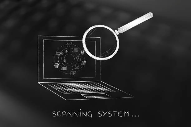 laptop analyzed by magnifying glass, antivirus scan stock photo