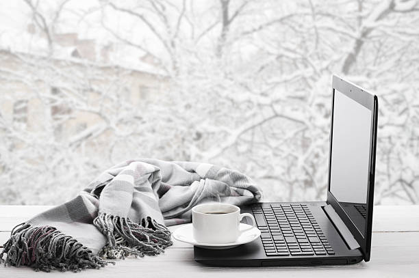 Laptop and coffee on winter window Cozy winter still life: laptop, cup of hot coffee and warm plaid on windowsill against snow landscape from outside. sunday morning coffee stock pictures, royalty-free photos & images