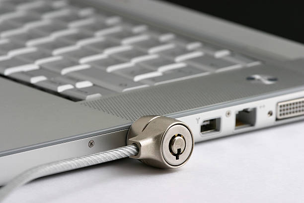 Laptop locked with Security cable lock  steel cable stock pictures, royalty-free photos & images