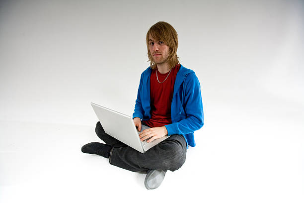 laptop man crossed legged stock photo