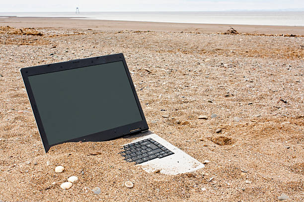 laptop personal computer on the beach stock photo