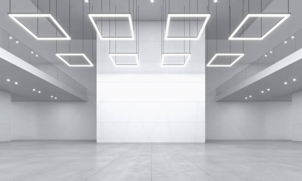 Large and empty exhibition space with white walls and bright light stock photo