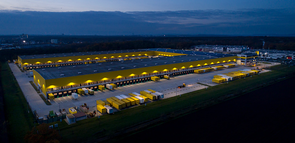 Large distribution hub, trucks and trailers - aerial view at dusk