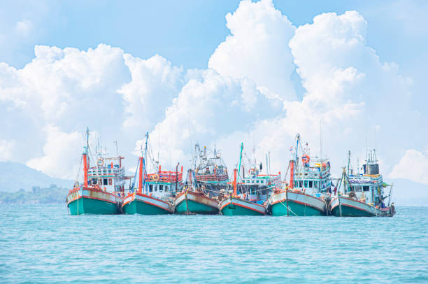 Large fishing boats moored in the sea. stock photo