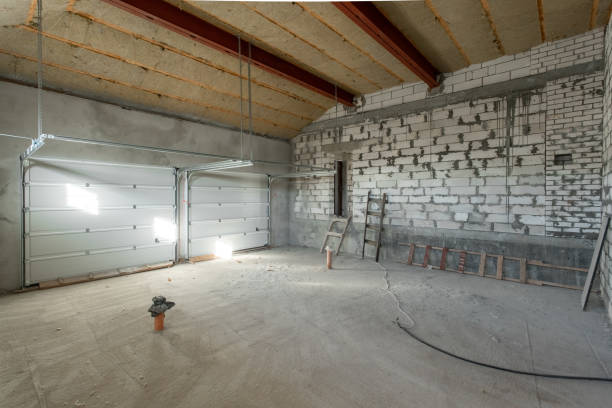 Large garage for two cars with of the gate. overhaul and reconstruction. Working process of warming inside part of roof. House or apartment is under construction, remodeling, renovation, restoration. stock photo