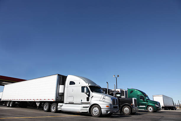 A large group of heavy trucks parked  stock photo