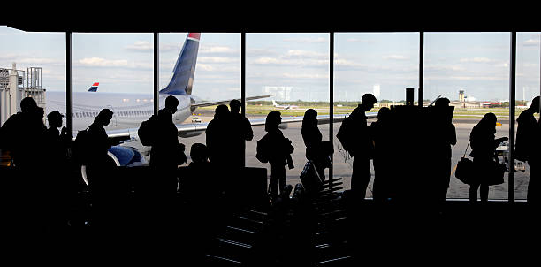 large group of people queuing - silhouette stock photo