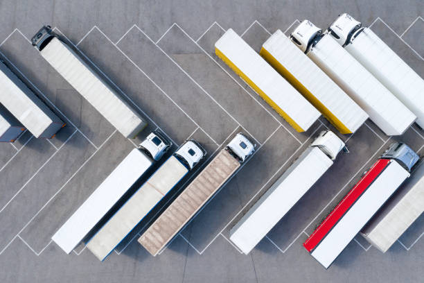 Large Group of Trucks at Truck Stop, Aerial View Heavy goods transportation - trucks in truck stop from above. semi truck stock pictures, royalty-free photos & images