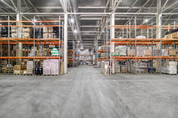 Large hangar warehouse industrial and logistics companies. Large hangar warehouse industrial and logistics companies. Warehousing on the floor and called the high shelves. construction material stock pictures, royalty-free photos & images