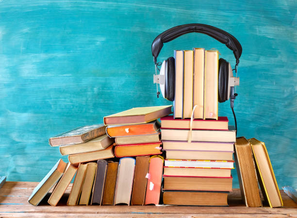 Large heap of books and heaphones, audio books concept, entertainment and education during corona lockdown stock photo