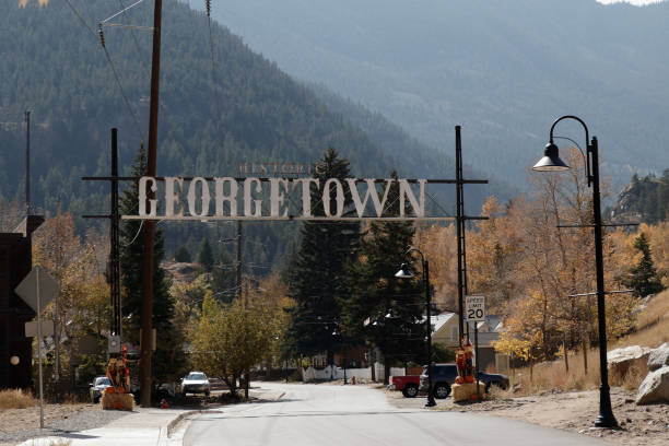 Large Historic Georgetown Sign Over a Road in the Mountains stock photo