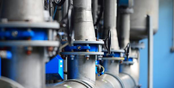 Large industrial water treatment and boiler room. Piping, flanges, butterlfy valves, rusty and corroded bolts stock photo