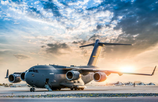 Large military transport aircraft at sunset Large military transport aircraft at sunset. military base stock pictures, royalty-free photos & images