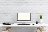 White brick wall, with PC working setup in front of it