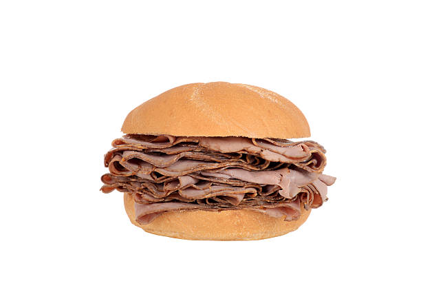 Large roast beef on a bun sandwich isolated Large roast beef on a bun sandwich roast beef sandwich stock pictures, royalty-free photos & images
