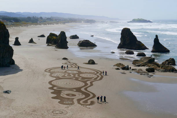 Large sand art drawing on a beach stock photo