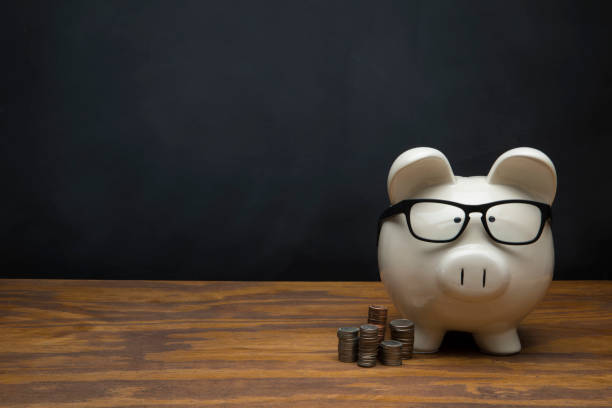 Large White Piggy Bank with Blank sign on Black Chalkboard Background This is a photograph of a large white Piggy Bank sitting on a desk a with a chalk drawing of a blank sign on Black Chalkboard Background. This image could relate to savings and retirement. 401k stock pictures, royalty-free photos & images