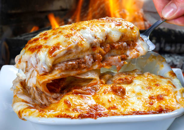 Lasagna Bolognese baked in the wood oven stock photo