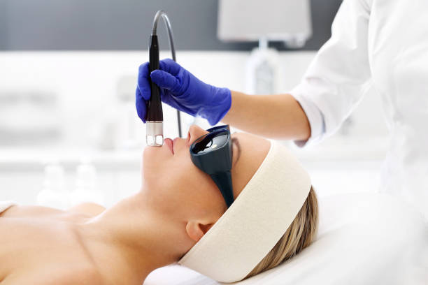 Laser treatment for the face. A woman in a beauty salon during a laser treatment. laser stock pictures, royalty-free photos & images