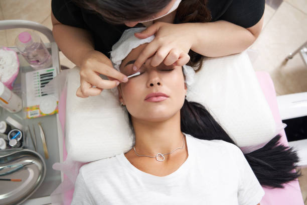 lash laminating and painting, closeup face. Beauty procedures in cosmetology clinic stock photo