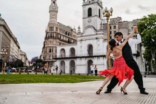 Latin couple dancing tango on town square stock photo