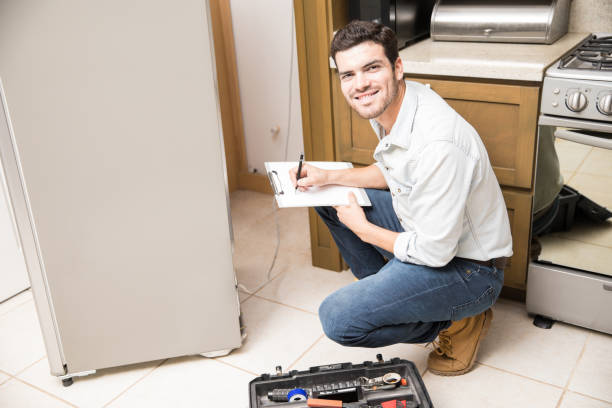 latin-handyman-fixing-a-fridge