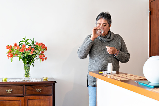 elderly Latina between 60-69 years taking medication at home