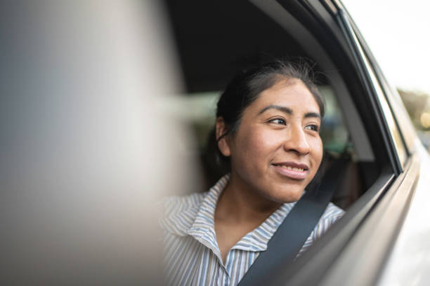 Latin woman in a taxi contemplating the city Latin woman in a taxi contemplating the city peru woman stock pictures, royalty-free photos & images
