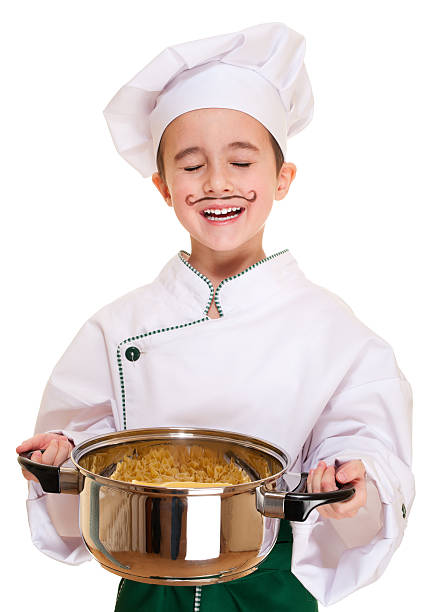 Laughing cookee boy hood with pot in hands stock photo
