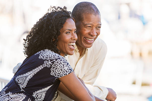 Laughing Couple Mature African American couple hugging and laughing old black couple in love stock pictures, royalty-free photos & images