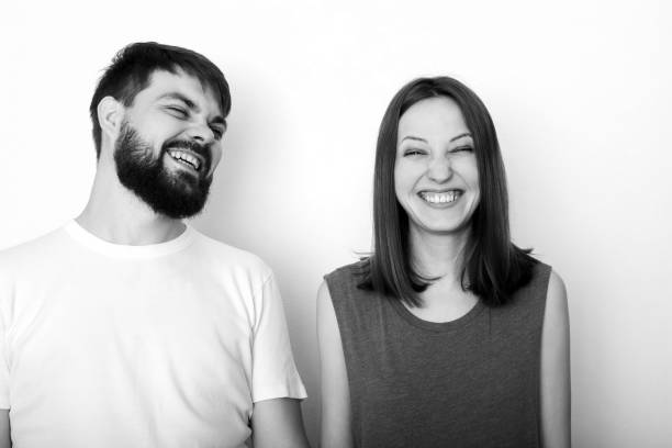 Laughing young couple in studio stock photo