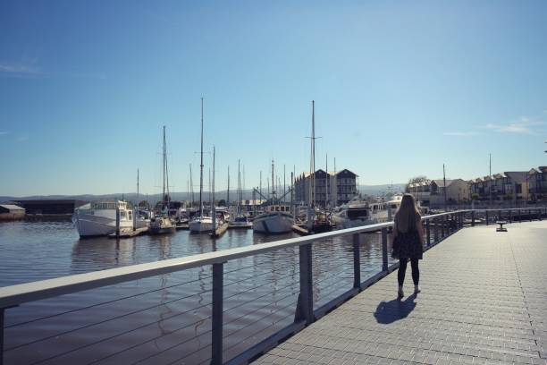 Launceston Seaport boardwalk young female walking on the boardwalk on a summer day launceston australia stock pictures, royalty-free photos & images