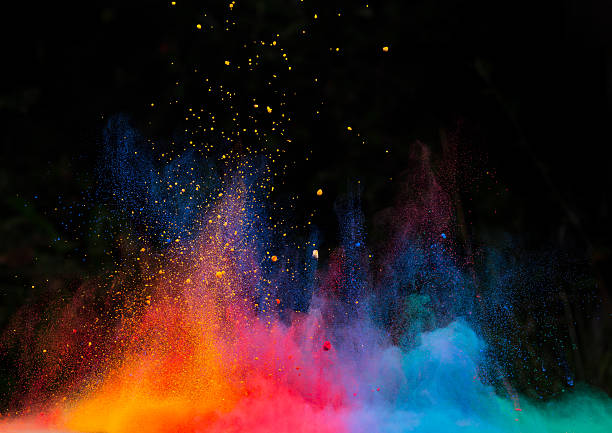 launched colorful powder over black stock photo