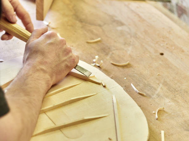 Lautner makes a classic guitar. Luthier gives a chamfered shape to the brace. stock photo