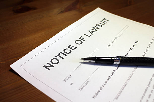 Lawsuit Document Someone filling out Notice of Lawsuit Form. lawsuit stock pictures, royalty-free photos & images