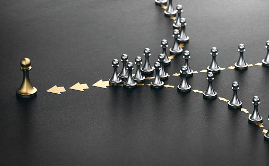 3D illustration of many pawns in a row over black background. Concept of lead. Following the leader.
