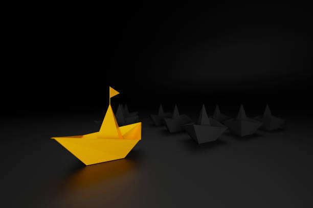 Leadership concept. Gold paper ship among black on black background. 3d render illustration stock photo