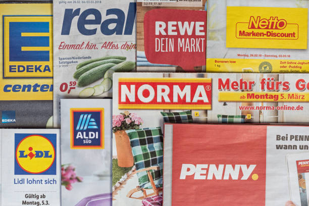 Leaflets and flyers of German supermarket chains Amberg, Germany - February 26, 2018: Advertising leaflets of some German supermarket chains. Logos and brands are visible. Lidl, Aldi Süd, Penny Markt, Norma, Netto, Edeka, Real, Rewe. lidl stock pictures, royalty-free photos & images
