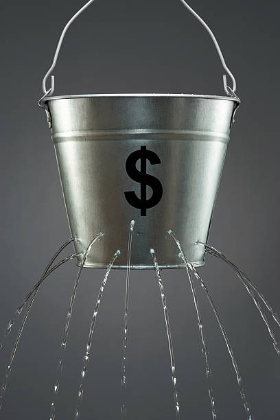 Leaky Dollar Bucket Leaky Dollar Bucket bucket stock pictures, royalty-free photos & images