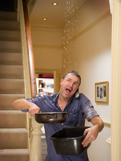 leaky pipe homeowner calls for help as his pipes burst leaking stock pictures, royalty-free photos & images